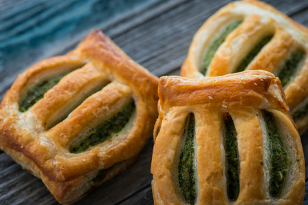 Freshly baked spinach pie on a wooden tableの写真素材