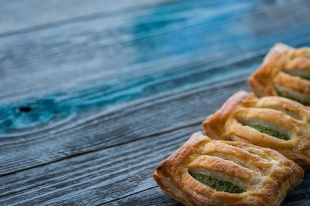 Freshly baked spinach pie on a wooden tableの写真素材