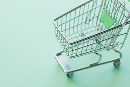 Empty shopping cart over the soft green backgroundの写真素材