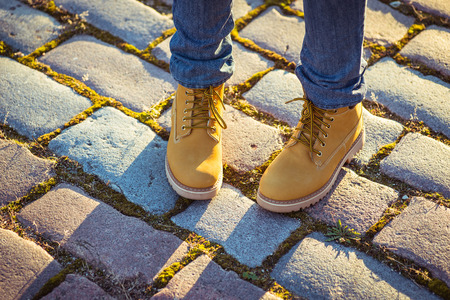 Warm yellow boots. Walking in yellow autumn leaves