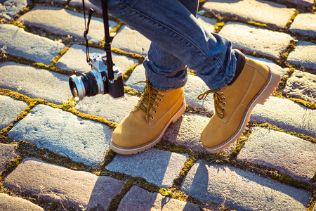 Warm yellow boots. Walking in yellow autumn leavesの写真素材