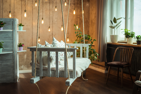 Interior design. White hanging bench with vintage bulbsの写真素材