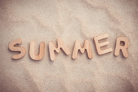 Summer. Wooden letters on the sand under the sunの写真素材