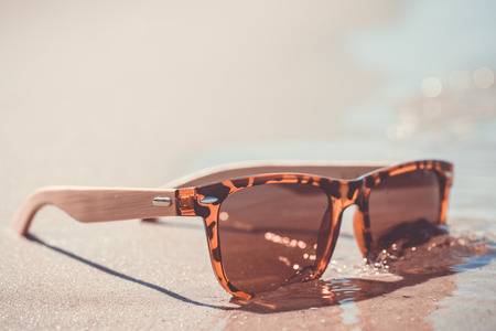 Summer. Vintage sunglasses on the sandの写真素材