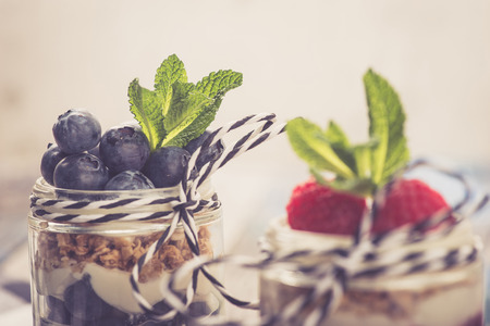 Parfait. Raspberries and blueberries with greek yogurt and granolaの写真素材
