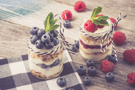 Parfait. Raspberries and blueberries with greek yogurt and granolaの写真素材
