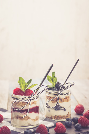 Parfait. Raspberries and blueberries with greek yogurt and granolaの写真素材