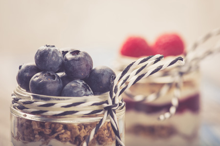 Parfait. Raspberries and blueberries with greek yogurt and granolaの写真素材