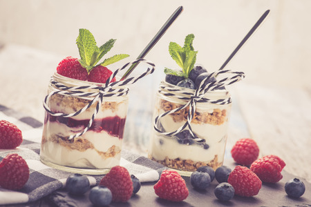 Parfait. Raspberries and blueberries with greek yogurt and granolaの写真素材