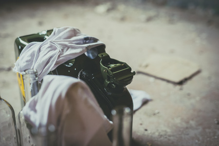 Terrorism. Molotov cocktail. Green military jerrycan with empty bottles and clothの写真素材