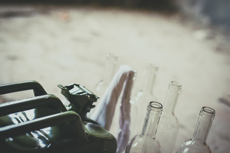 Terrorism. Molotov cocktail. Green military jerrycan with empty bottles and clothの写真素材