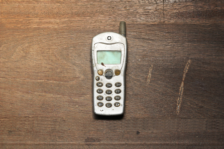 old mobile phone on wooden tableの写真素材