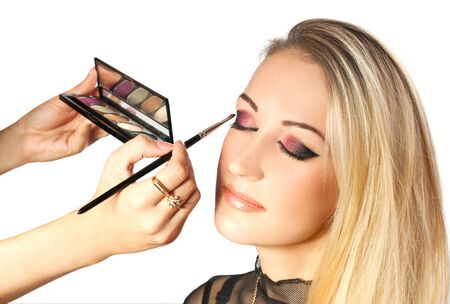 Visagist making makeup for beatiful young girlの写真素材