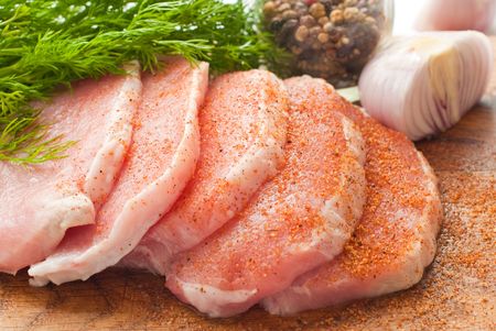 Chunks of pork on the broad with onion and fennelの写真素材