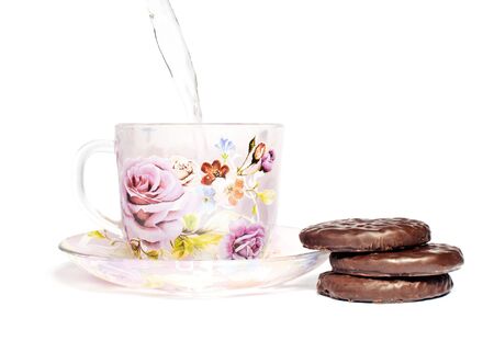 A cup of tea on the saucer with chocolate cookiesの写真素材