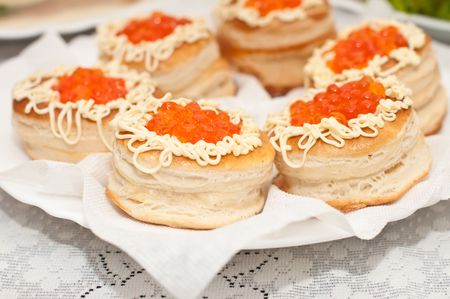 A few biscuits with red caviar and mayonnaise on the plateの写真素材