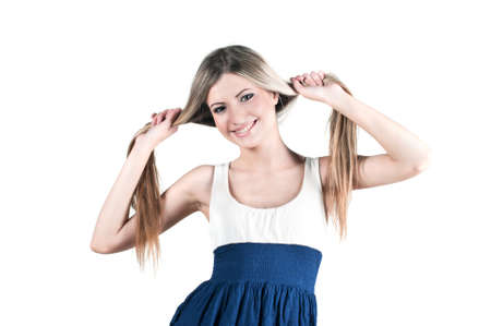 Isolated on white cheerful young beautiful blond girl with two tailsの写真素材