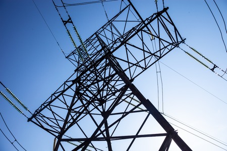 Electricity pylon against the blue sky background の写真素材