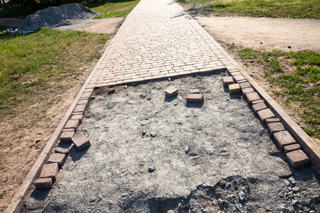 Paving the footpath with the tiled cubes.