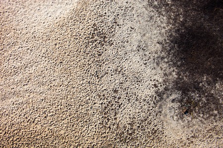 Sand surface after the rain with the visible traces of the raindrops and water currentsの写真素材