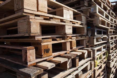 The big stack of wooden cargo pallets.