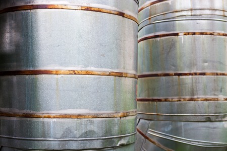 Close up of two vertical metal pipelines.