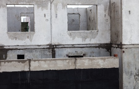 Unfinished grey concrete building in the construction site.の写真素材