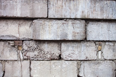 Grey wall constructed of the concrete blocks.