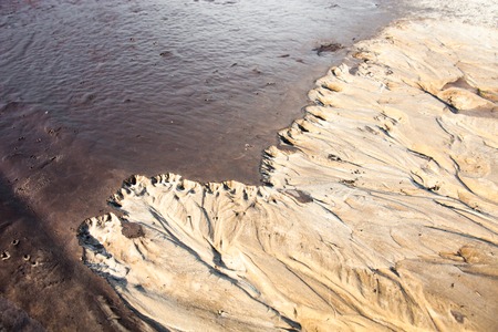 Sand surface after the rain with the relief formed by water currents.の写真素材