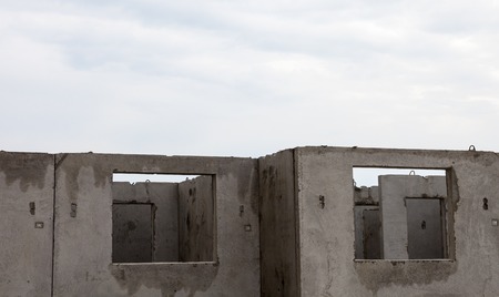 Unfinished grey concrete building in the construction site.の写真素材