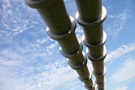 Elevated section of the pipelines against the cloudy skyの写真素材