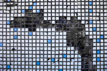 Surface of the old and damaged small square tiles.