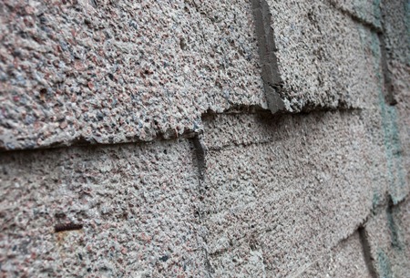Grey wall constructed of the concrete blocks.