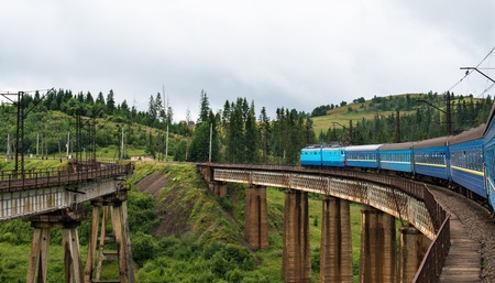 Passenger train going across the bridge in the Carpathian Mountainsのeditorial素材