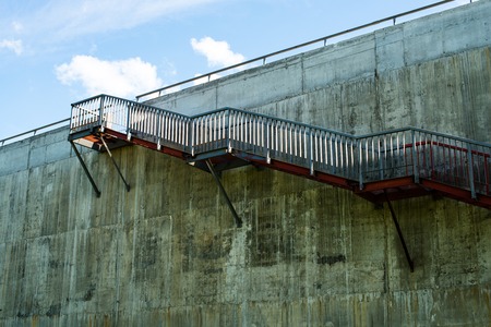 Metal stairs on the gray concrete wall.の写真素材