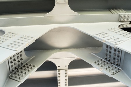 Gray metal framework of the bridge. Industrial surface. Close up.