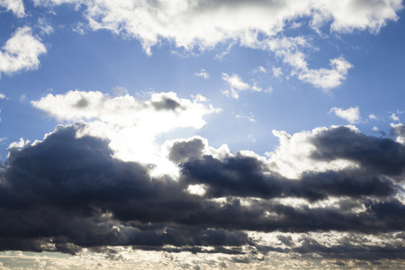 Cloudscape with the sun rays radiating from behind the clouds