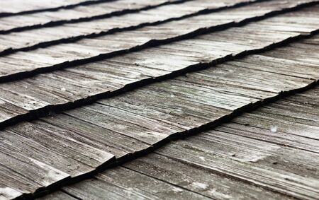 Old wooden shingle roof. Wooden surface texture.の写真素材
