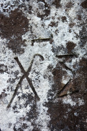 The surface of the old cross gravestone with engraved Old Church Slavonic inscriptions. Kyiv, Ukraine. Close up.の写真素材