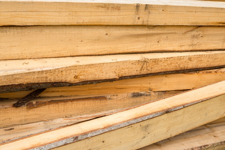 Pile of wooden beams in the construction site. Close up.の写真素材