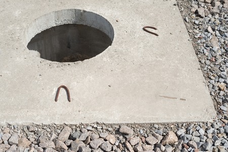 Manhole without cover in new concrete block.