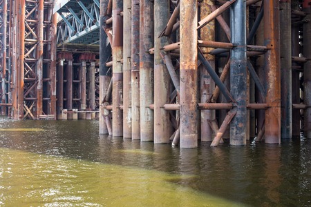 Bridge construction. Rusty metal piers of the unfinished bridge across the Dnieper in Kyiv (Ukraine).の写真素材