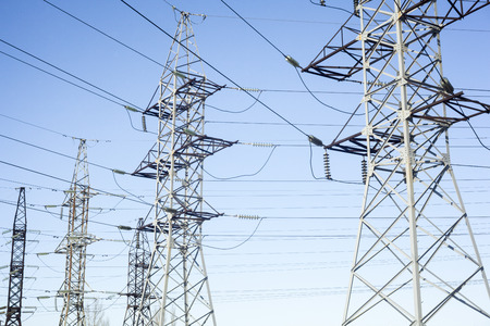 System of the electricity pylons against the blue sky.