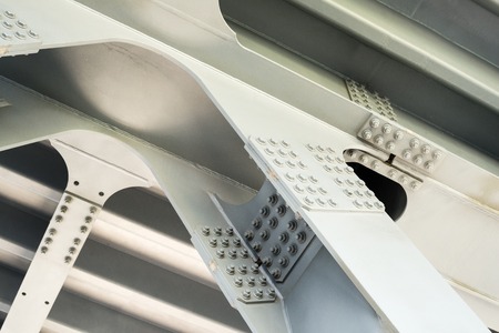 Gray metal framework of the bridge. Industrial surface. Close up.