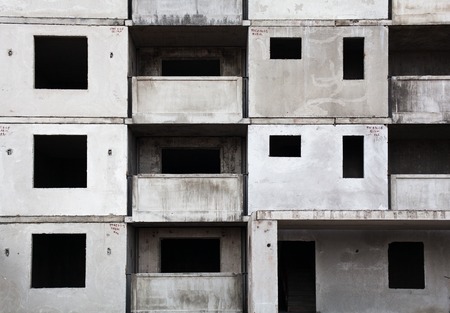 Unfinished grey concrete building in the construction site.