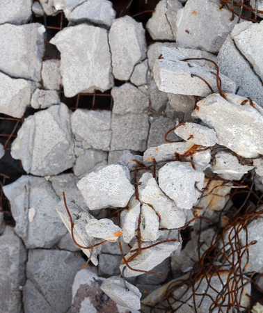 Cracked concrete block with visible rusty reinforcement bars. Close-up.の写真素材