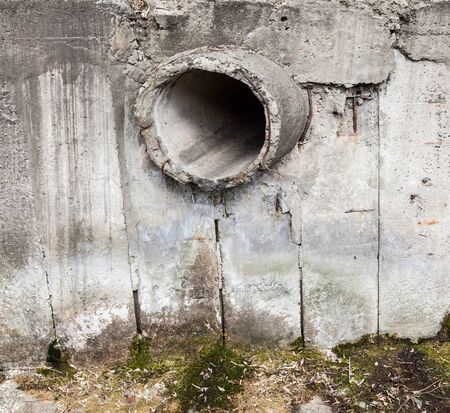 Roncrete run-off pipe in the concrete wall. Round orifice.の写真素材
