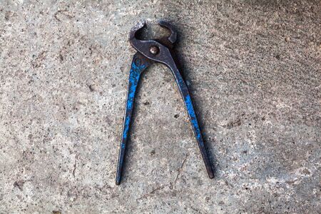 Old blue metal pincers. Hand tool. Close-up.の写真素材