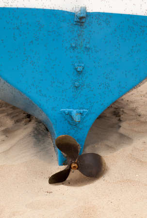 Boat on the beach. Three blades propeller. Mosquitos on the boat.