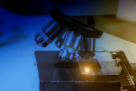 Close up shot of microscope at the laboratory take with art lighting and blue filter